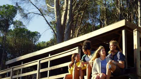 friends sitting on stair and interacting with each other in cabin 4k