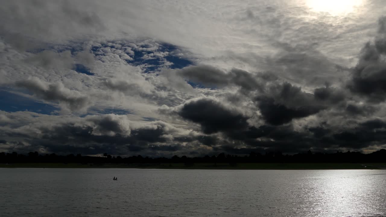 호수의 정상적인 속도로 황혼에 극적인 하늘의 시간 경과