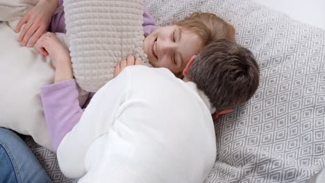 mother and daughter playfully lying down