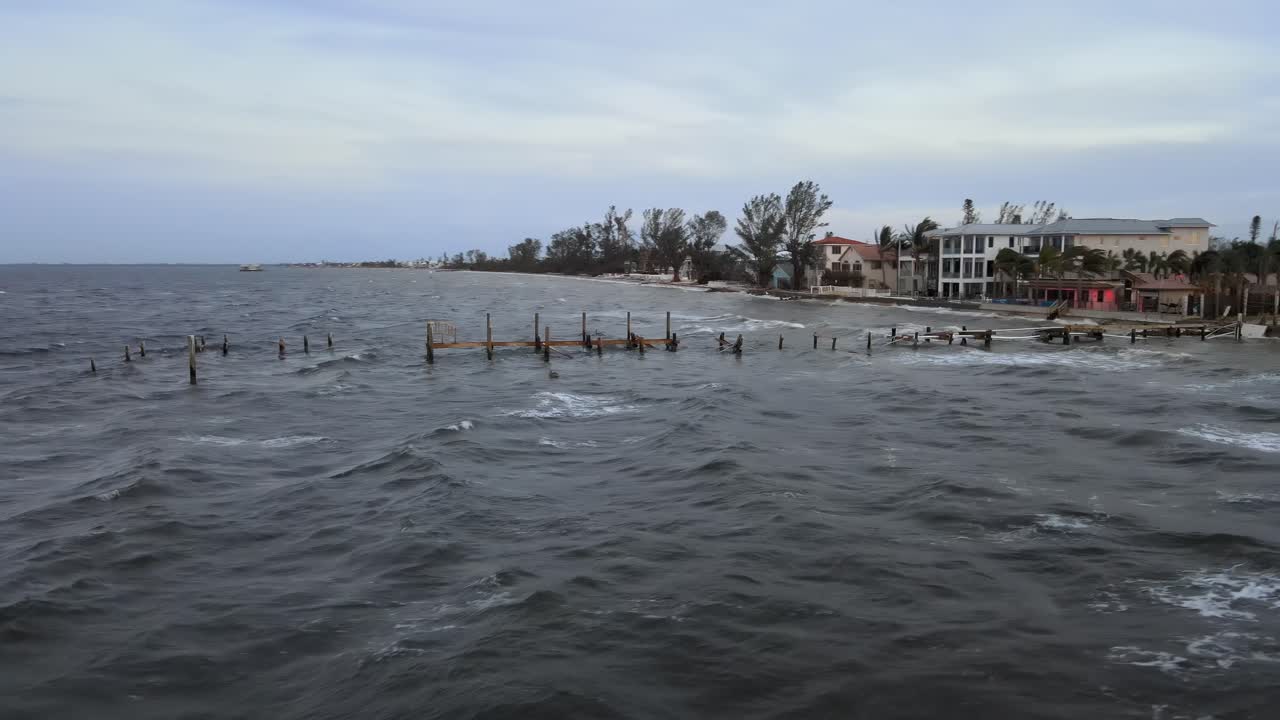 Aerial of the destroyed Rod and Reel Pier in Anna Maria Island, Florida at sunset after Hurricane Milton.