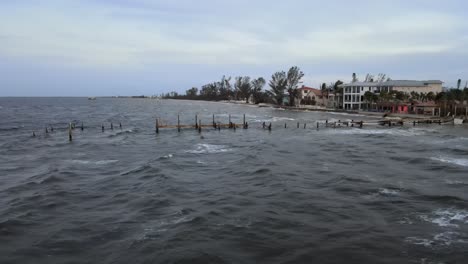 aerial of the destroyed rod and reel pier in anna maria island, florida at sunset after hurricane milton.