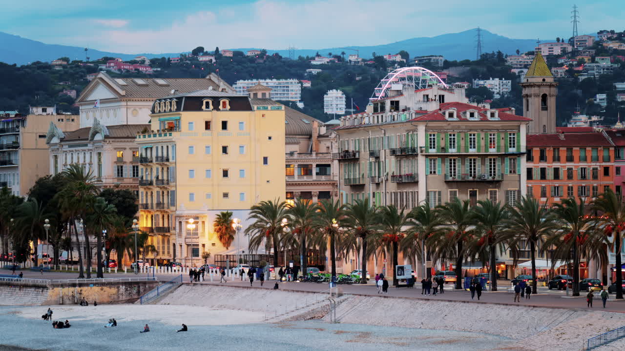Distant view of the Promenade des Anglais along the Mediterranean coast of Nice, France in the evening