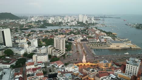 aerial drone fly above historic center cartagena, colombia panoramic city church landmark, avenue, street traffic and neighborhood buildings