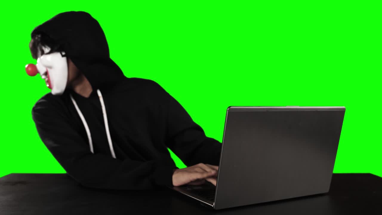 Masked hacker steals the secret data information