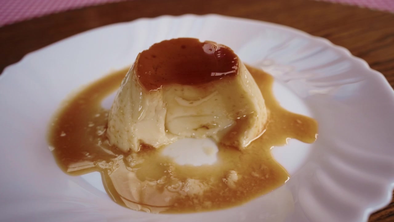 Close up of delicious crème caramel dessert, spoon slicing for a bite