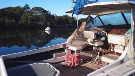 interior of a small old used fishing boat, panning right