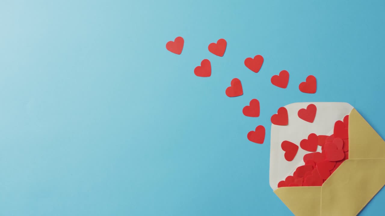 Envelope with paper hearts on blue background at valentine's day