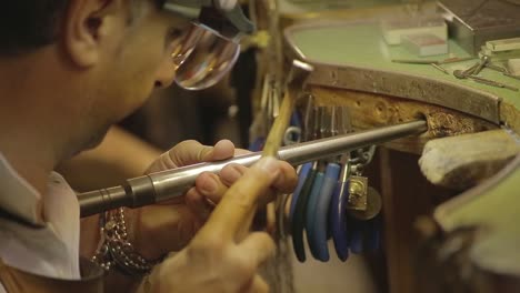 italian goldsmith at work building an engagement or a wedding ring