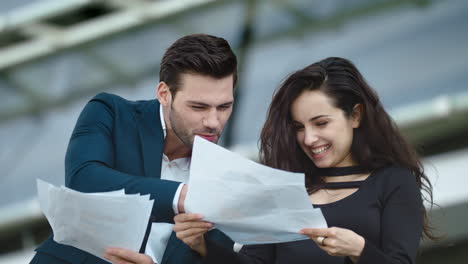 Closeup-business-partners-standing.-Business-partners-throwing-papers-at-street