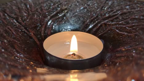 small candle burning peacefully and slowly, warm candlelight, close up