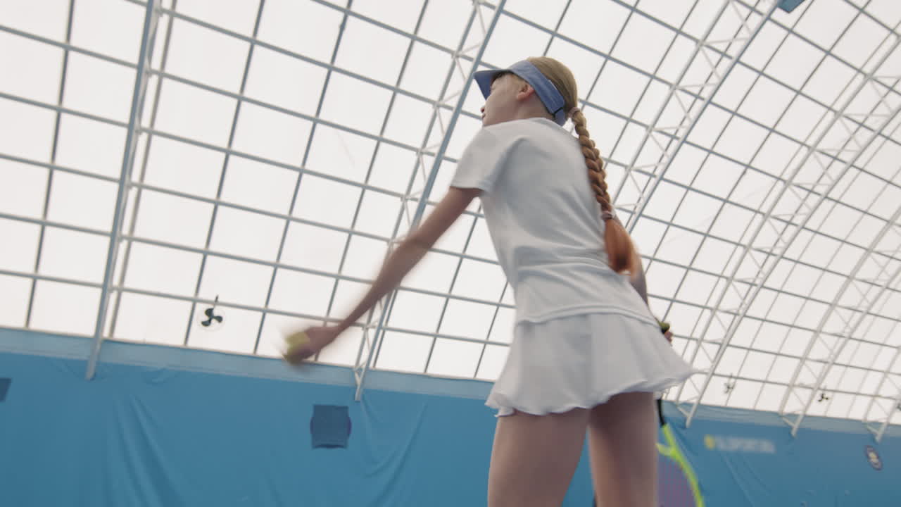 Little Girl Throwing And Hitting Tennis Ball