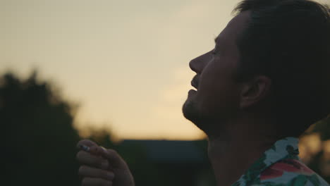man smoking at sunset