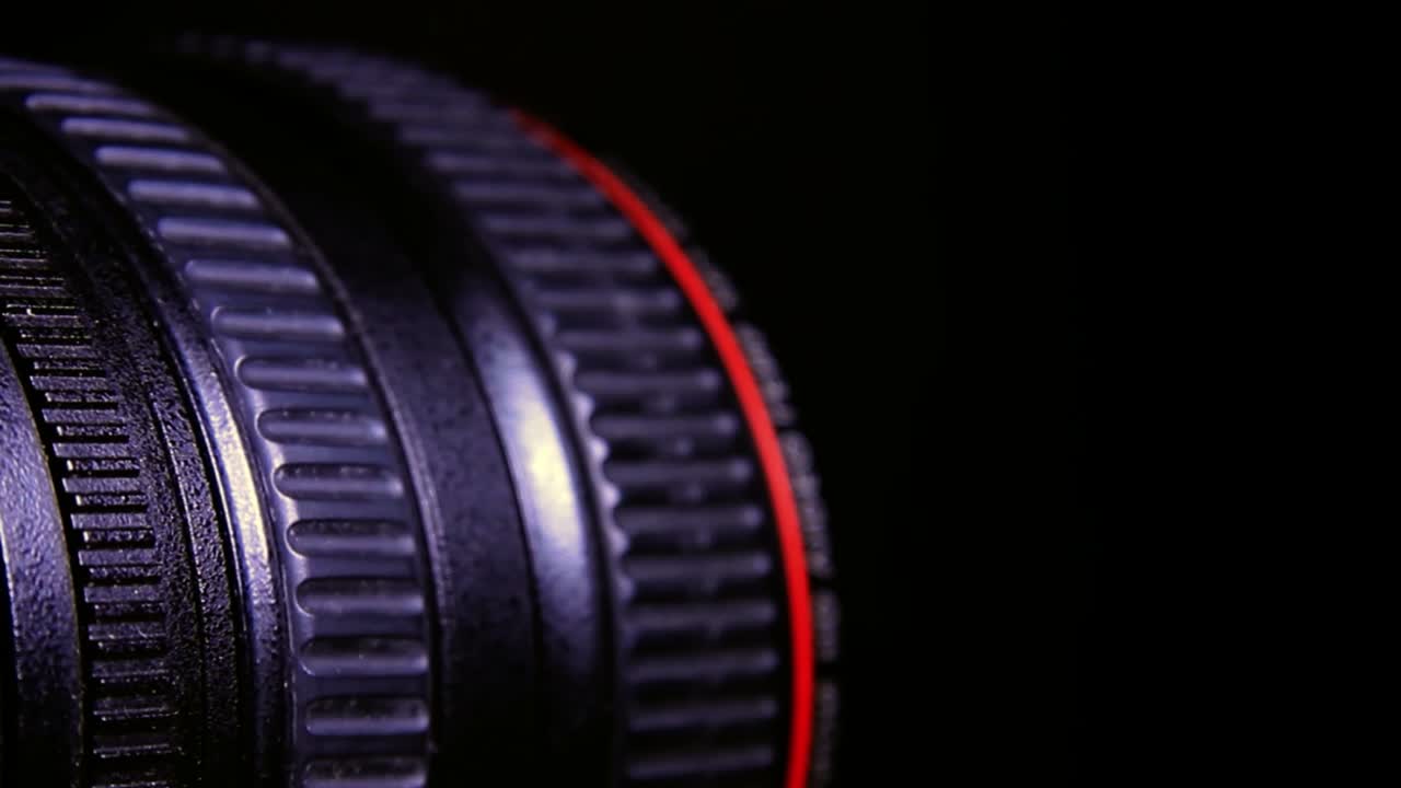Close Up of Moving Adjustment Rings on a Digital Video Camera Lens