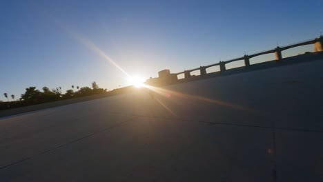 first person view drone orbiting over biker performing