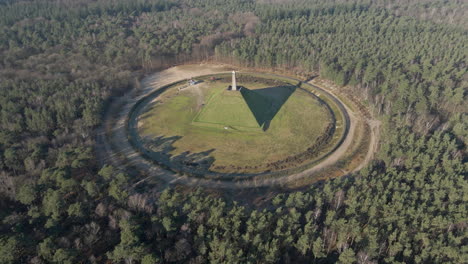 aerial of austerlitz pyramid in the netherlands on a sunny day - revealing beautiful surrounding forest. the piramide van austerlitz is a monument, built in 1804 as a tribute to napoleon bonaparte.