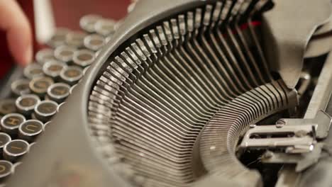 Close-up-of-typing-on-an-antique-typewriter-with-ink-and-ribbon