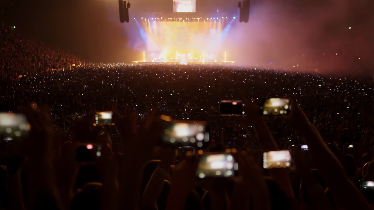 Crowd at a concert recording with smartphones