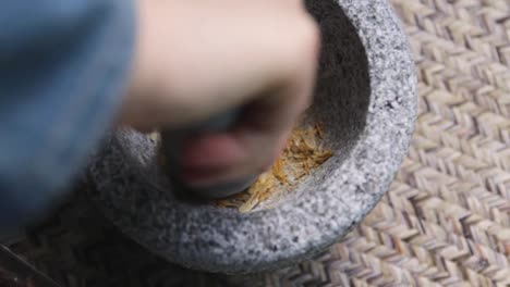 grinding spices in a mortar and pestle