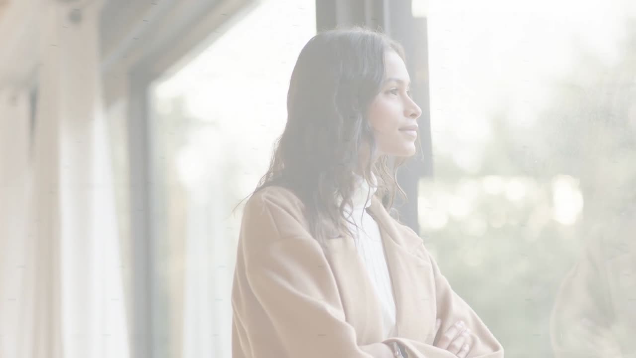 Woman by window gazing outward, thinking, faint bands fading, revealing fashion portrait