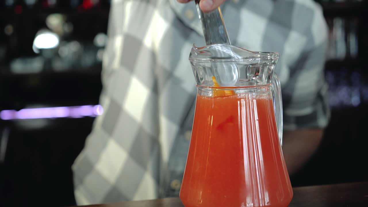 Bartender makes a refreshing lemonade. Cooking fresh juice