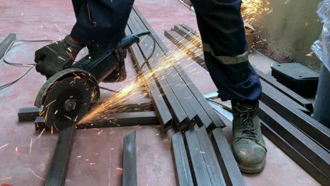 unrecognizable worker cutting iron with a radial