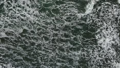 Birds-eye-view-of-calm-ocean-white-cap-waves-with-sea-foam