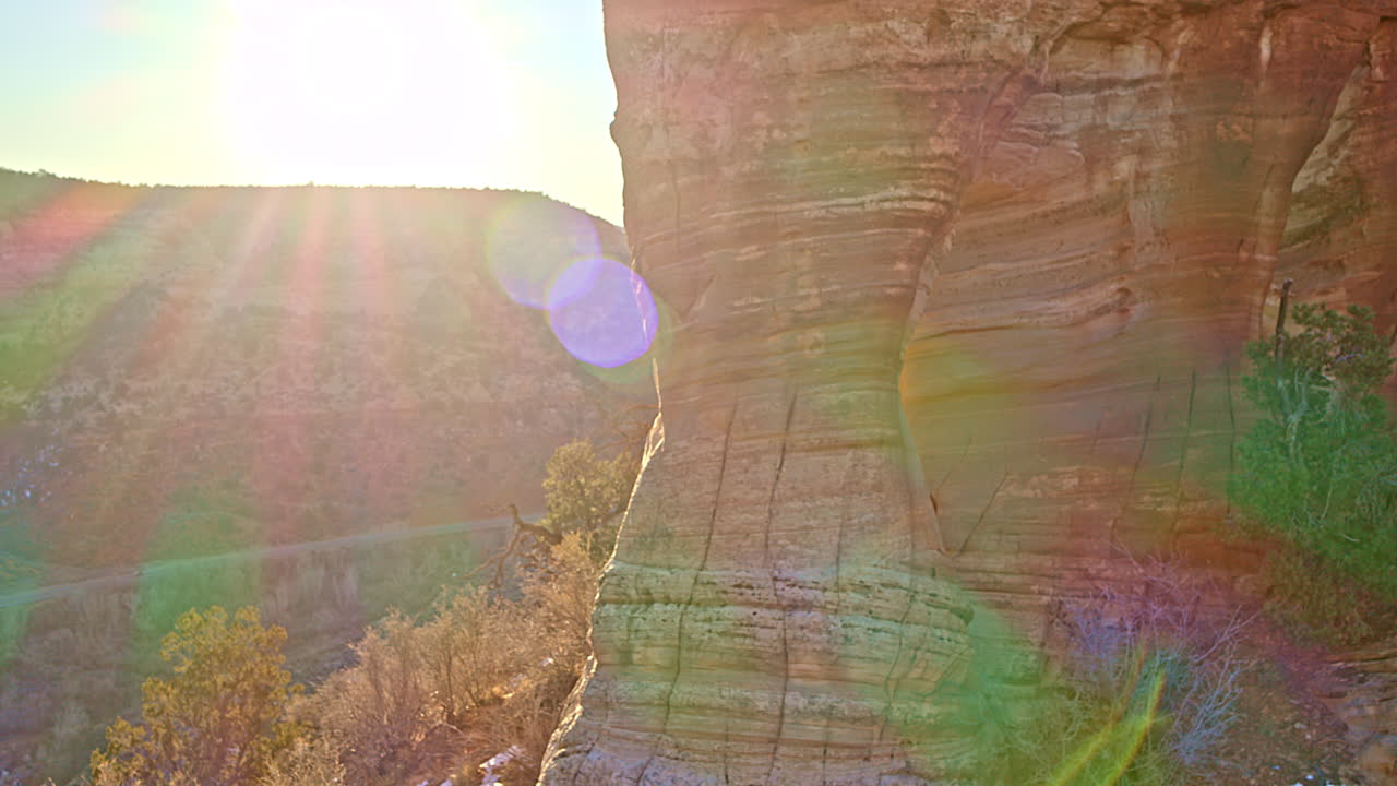 Drone shot showcasing a breathtaking natural arch bathed in sunrise light near Kanab, Utah.