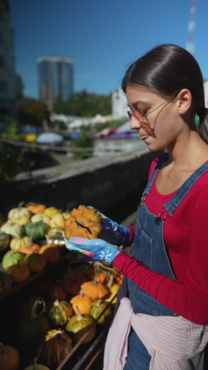 mujer sosteniendo una calabaza en un mercado en el techo