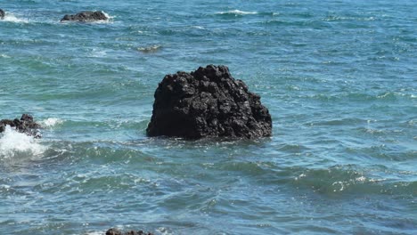 isolated volcanic rock in turbulent sea waters off tenerife coast