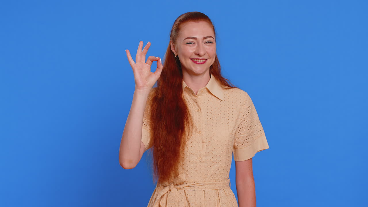 Woman looking approvingly showing ok approve feedback gesture like sign positive something good