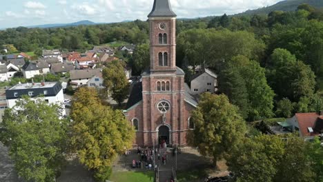 drone flies a horizontal curve with a church in view in baden-baden germany in the black forest