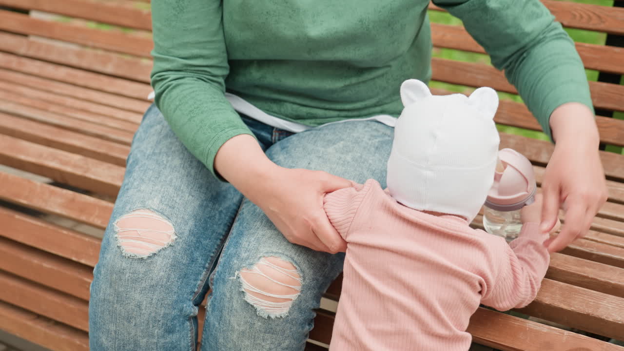 Mother And Baby Bonding, Child And Mother Sharing Tender Moments, Mother Gently Engaging With Infant On Park Bench, Warm Interaction Between Mother And Baby During Outdoor Playtime