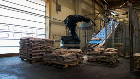 timelapse of a arm machine stacking leather sheets