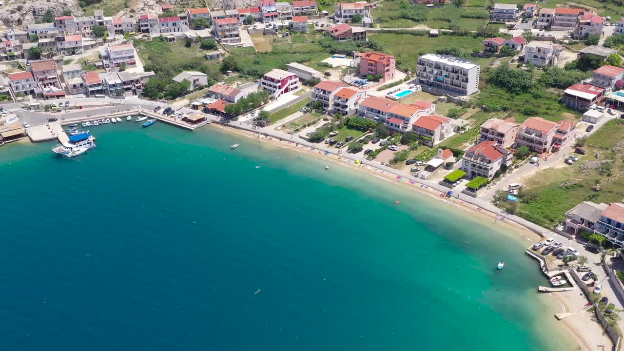 Metajna waterfront on the island of Otok Pag in Croatia with beach resorts, Aerial flyover view