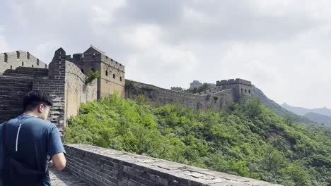 a man taking photos of the great wall of china