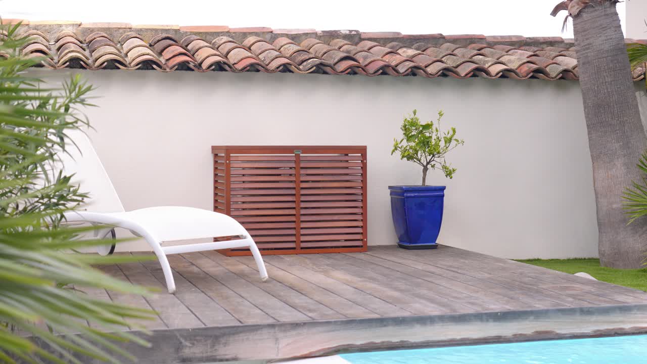 Stylish wooden air conditioner cover near a tranquil pool