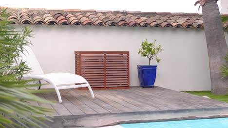 stylish wooden air conditioner cover near a tranquil pool