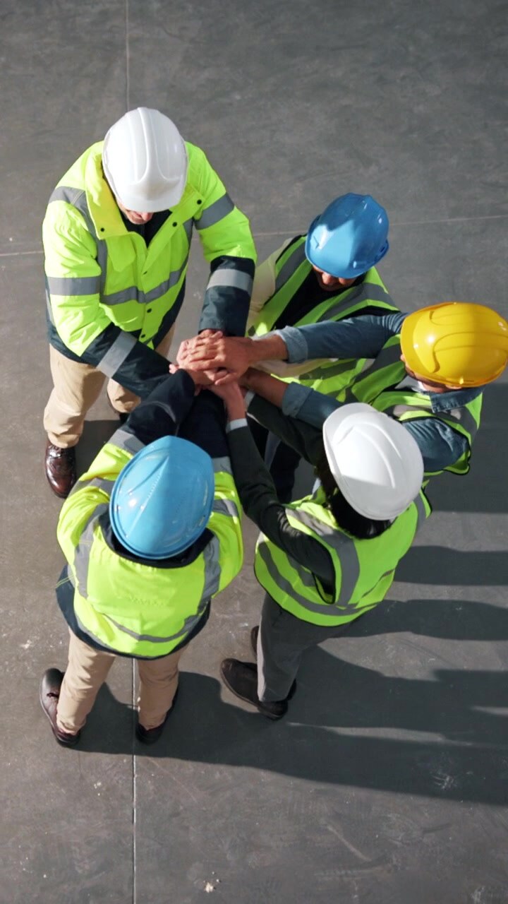 Construction Workers Celebrating Success with Team Huddle