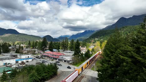 container trains moving on railroad tracks in the town of hope in british columbia, canada