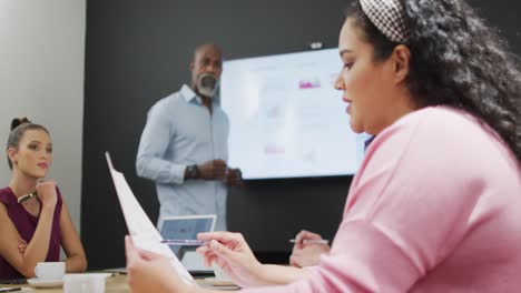 happy diverse business people discussing work during meeting at office