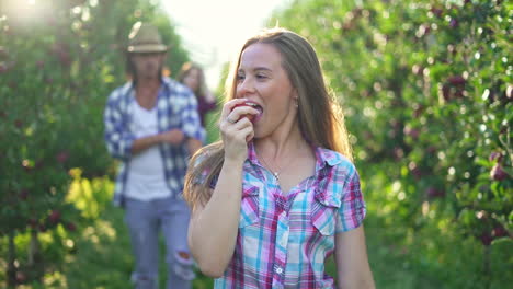 young people enjoying apple picking in a sunny orchard
