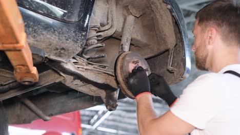 mechanic working on a car's brake system