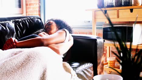 Lesbian-couple-sleeping-together-on-couch