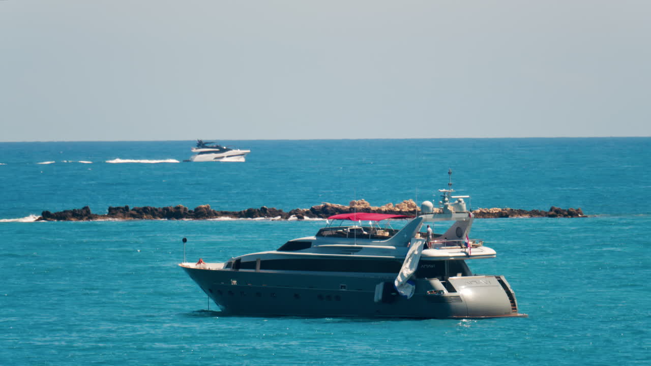 Antibes, France - May 24, 2025: Ships moving on the Mediterranean sea in daylight