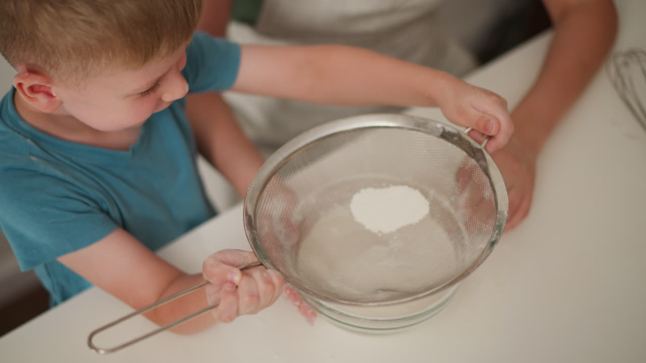 Child learning to bake with parent