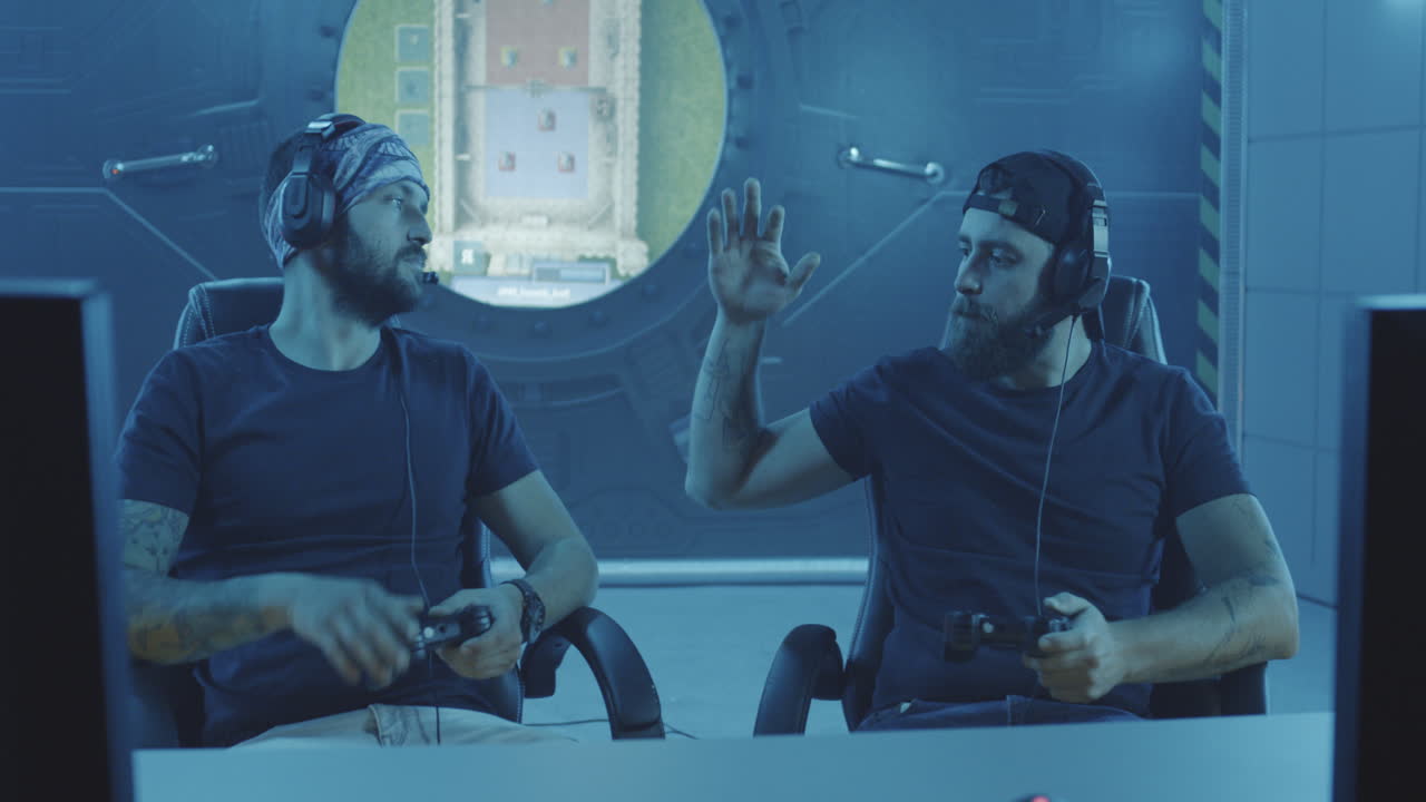 Young Men Playing a Match at a Gaming Tournament Medium Shot of Young Men Playing a Match at a Gaming Tournament and then Doing Fail Handshake