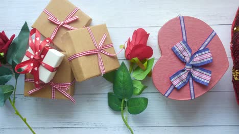 gifts and roses on a wooden table