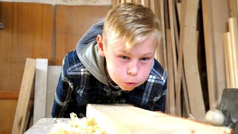 young boy learning woodworking