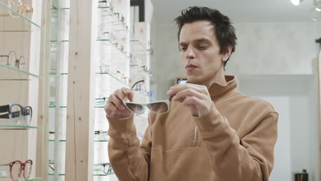 man shopping for eyeglasses in an optical store