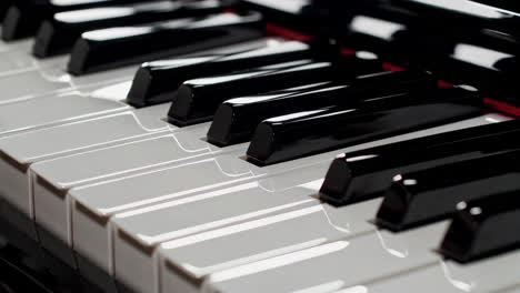 close-up of piano keys with a hand playing